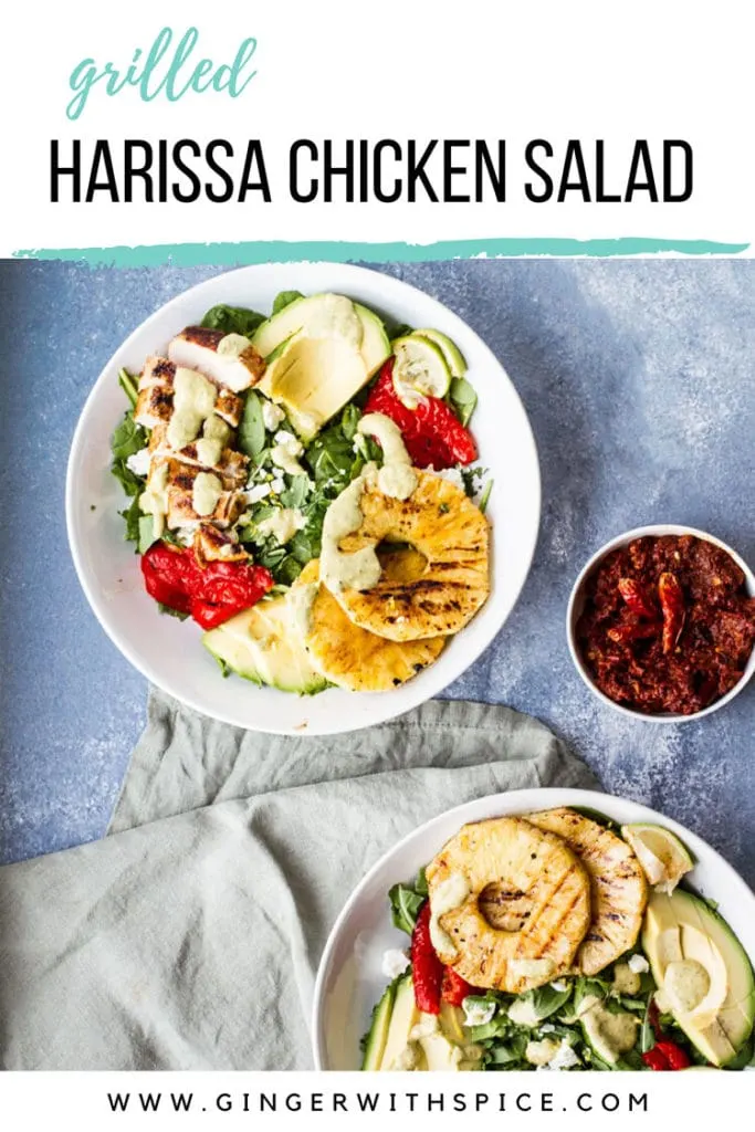 Large white bowl with salad ingredients like grilled pineapple and chicken and sliced avocado. Pinterest pin with text overlay.