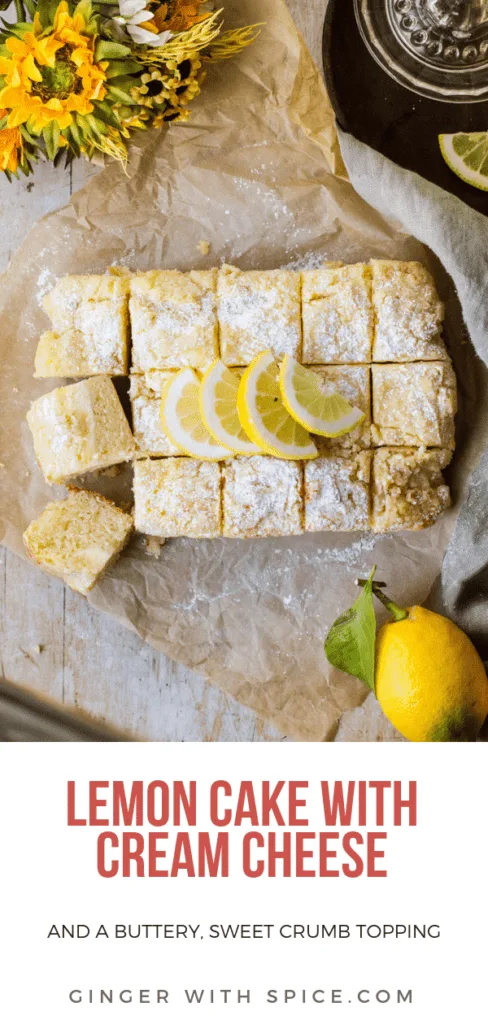 Lemon Cake with lemon slices and powdered sugar on top. Background is parchment paper and a green towel. Some yellow flowers and lemons in the corner. Pinterest pin.