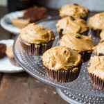 A cake stand with chocolate cupcakes and Baileys frosting.