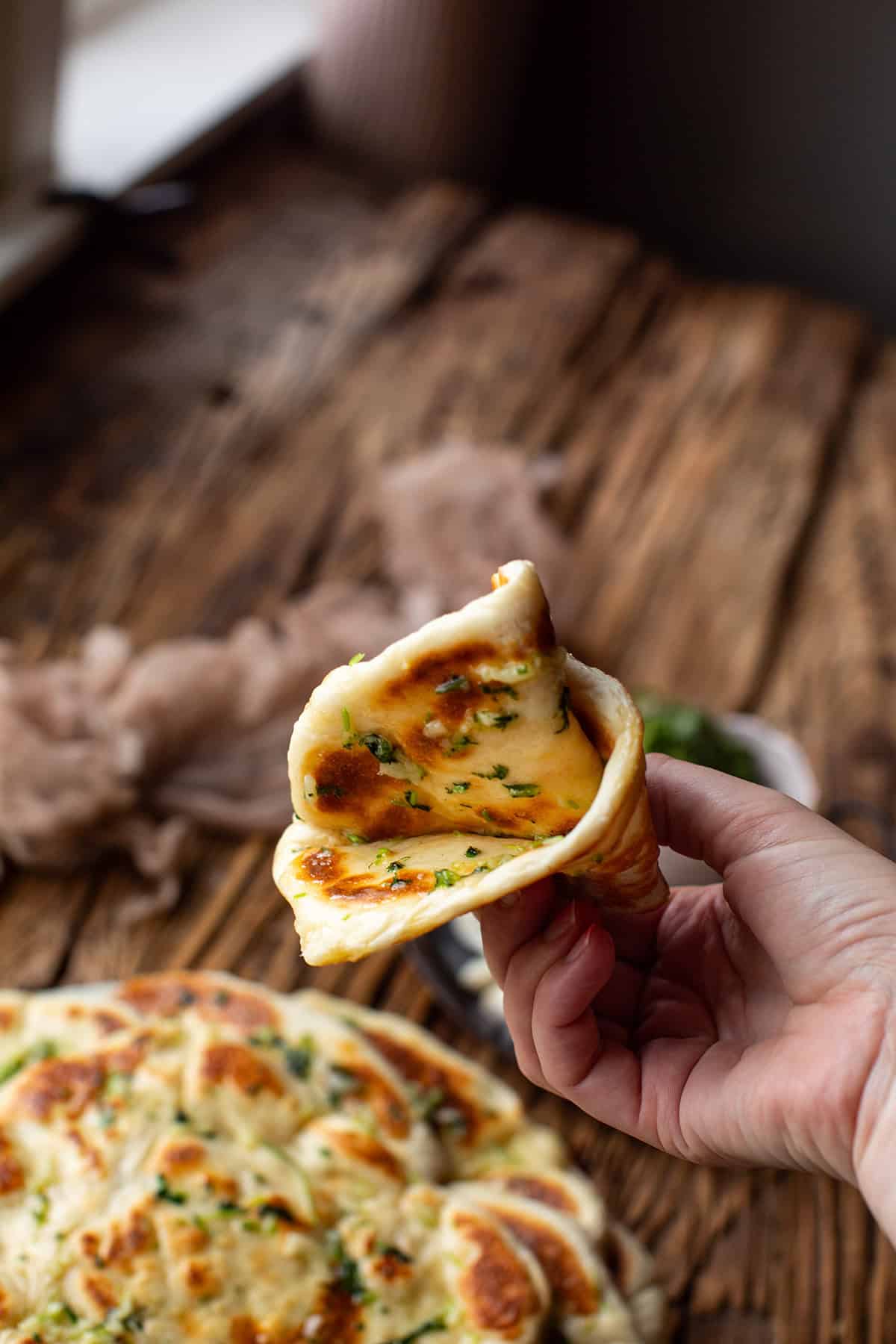 Hand crunching a naan together.