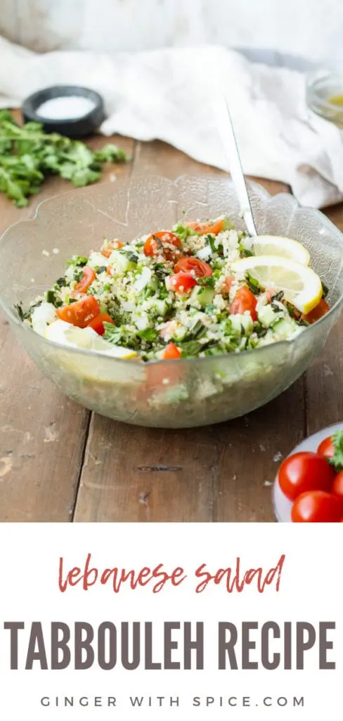 Tabbouleh and lemon wedges in a large glass bowl. Ingredients and towel blurred in the background. Pinterest pin.