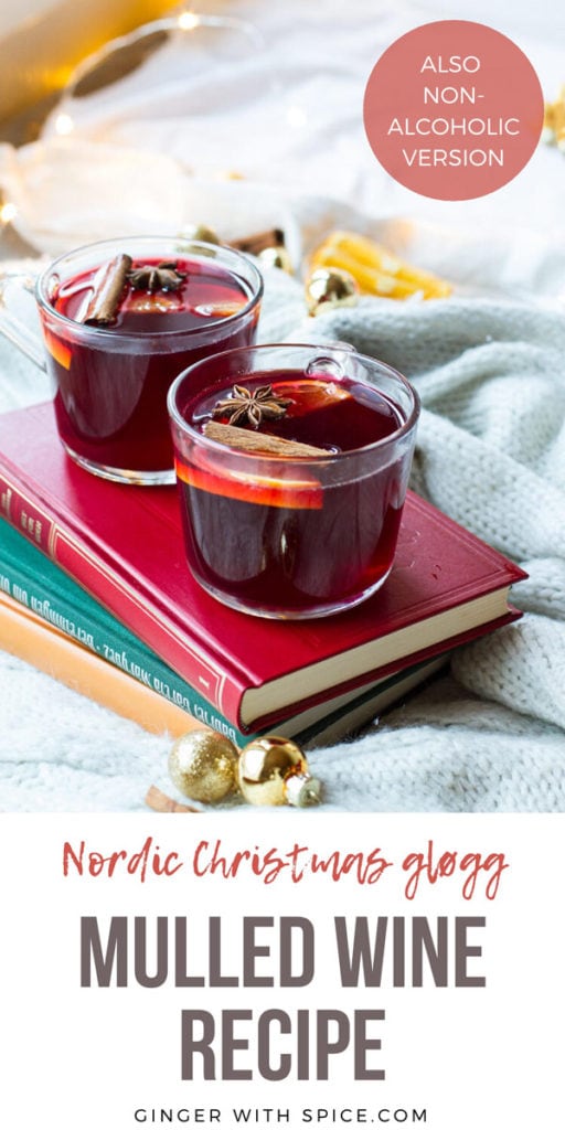 Glass mugs with mulled wine on a red book. Pinterest pin.