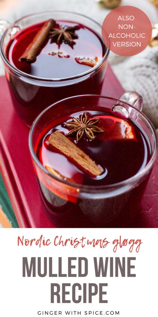 Two mugs with mulled wine garnished with cinnamon stick, star anise and clementine slice. Pinterest pin.