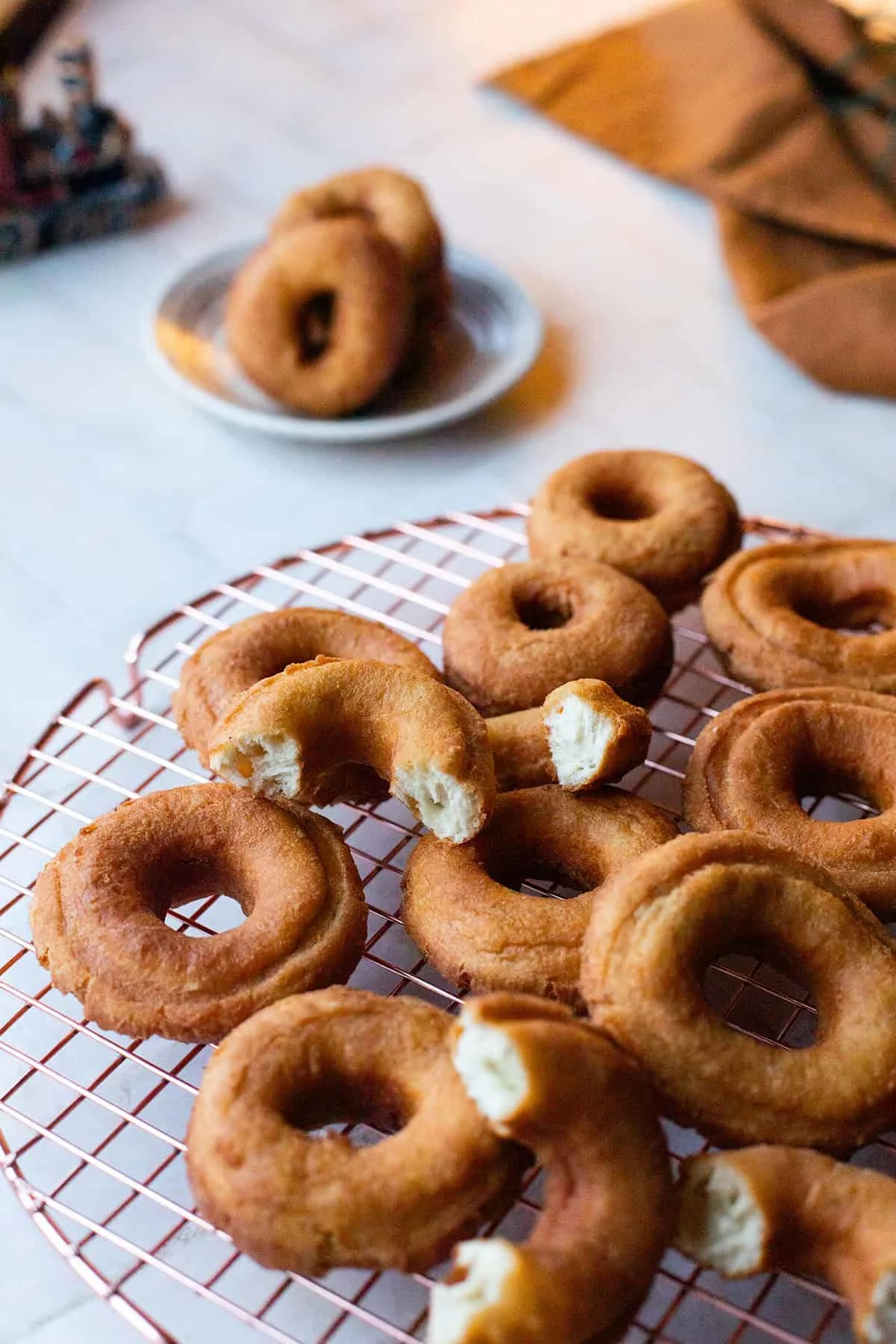 Cooling rack with fried donuts.