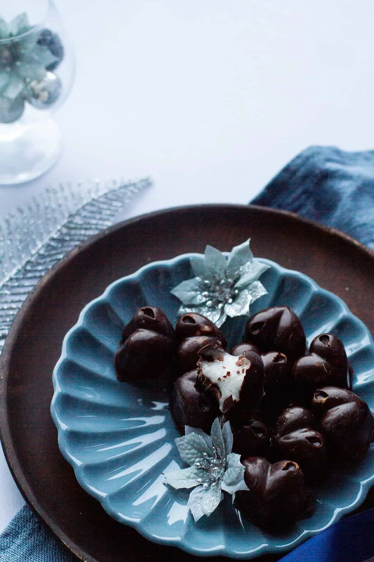 Heart-shaped chocolates on a blue plate. One cut open to show the insides.