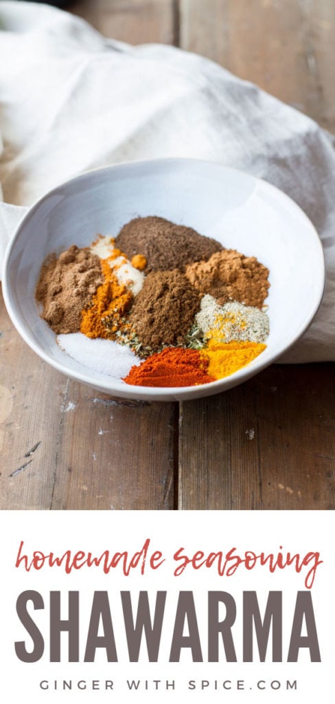 Shawarma spice blend in a blue bowl, wooden background. Pinterest pin.