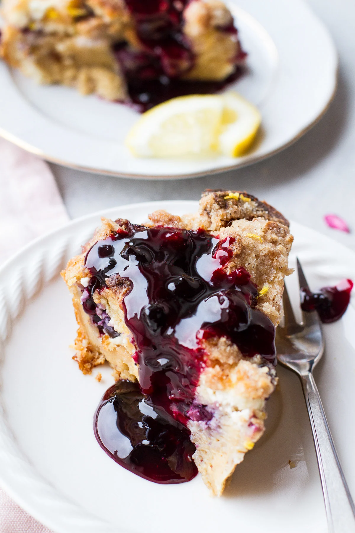 Close-up of a slice of French toast casserole wth blueberry sauce.