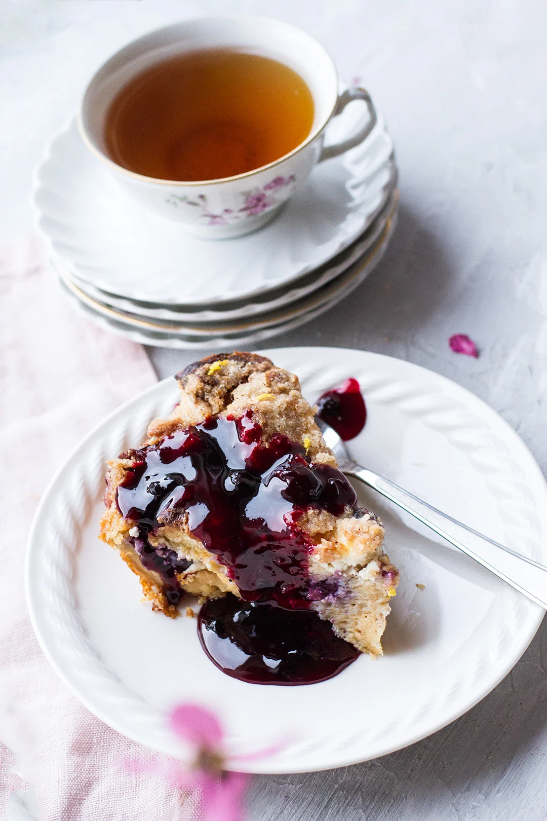 Slice of French toast casserole with blueberry sauce on top.