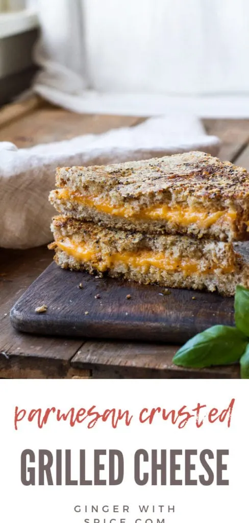 Parmesan crusted grilled cheese sandwich on a wooden cutting board.