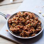 Sun dried tomato pesto in a small metal bowl.