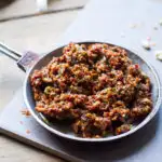 Sun dried tomato pesto in a small metal bowl.