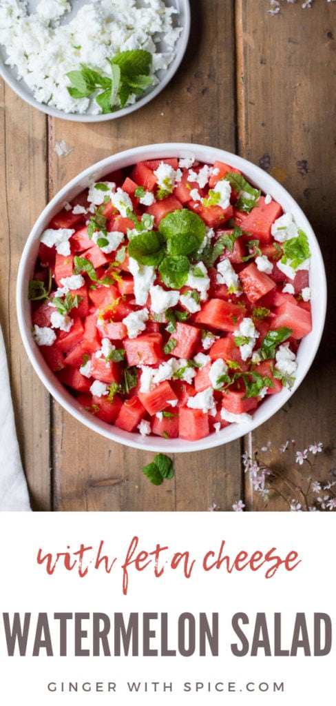 Watermelon salad in a white bowl on a wooden table, flatlay. Pinterest pin.