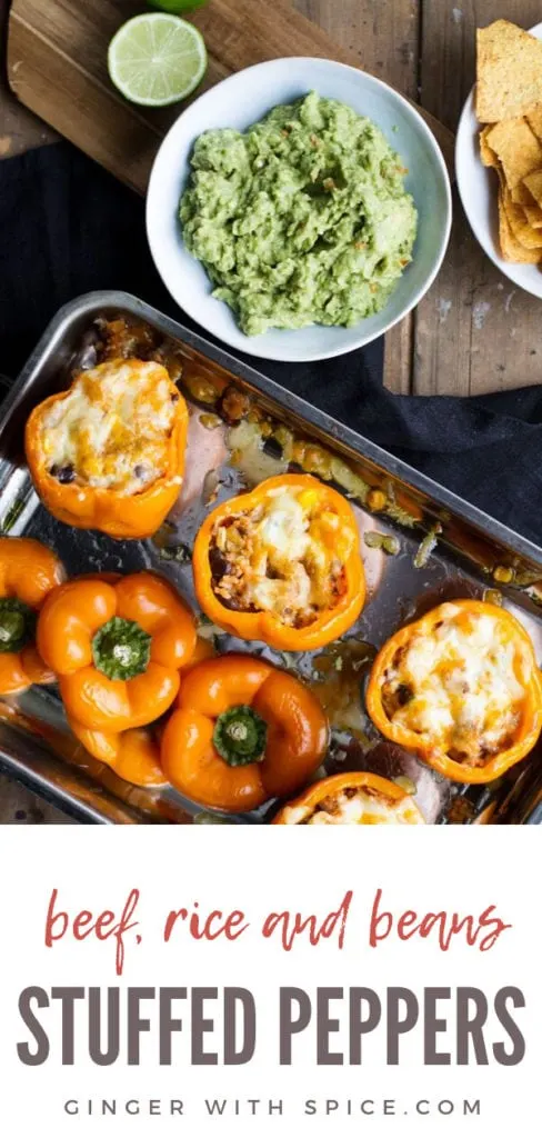 Stuffed peppers with melted cheese in a metal pan. Flatlay. Pinterest pin.