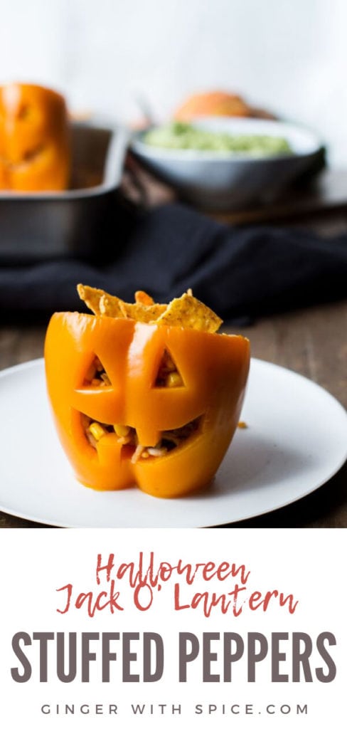 Halloween Jack O'Lantern stuffed peppers, straight angle. White plate. Pinterest pin.