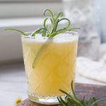 Apricot Rosemary Gin Fizz in a whiskey glass.