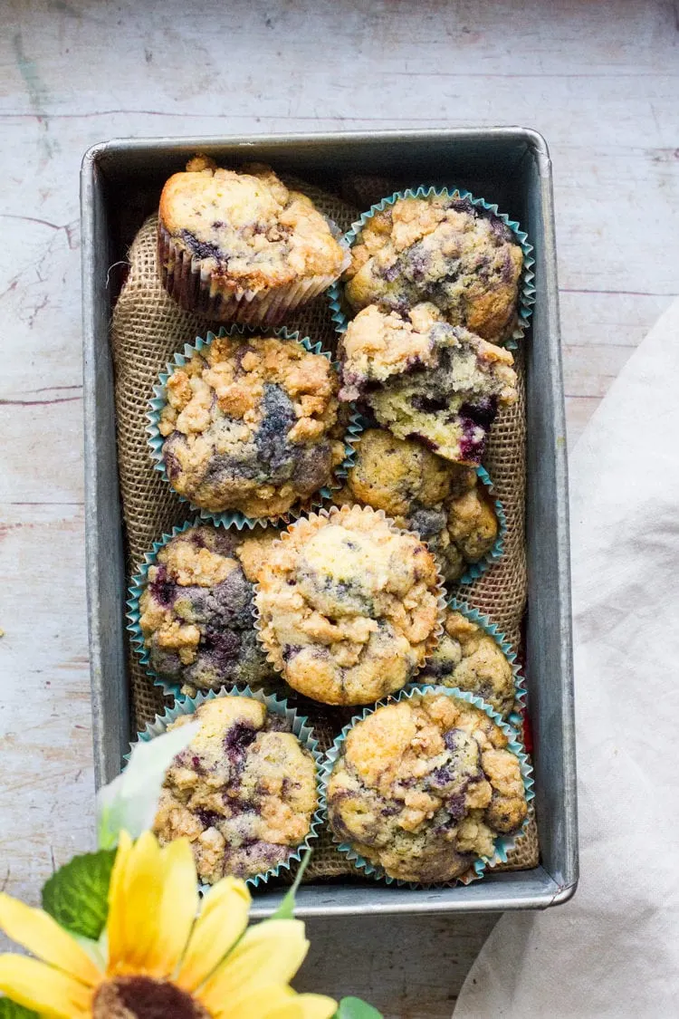 Homemade blueberry muffins in a metal box.