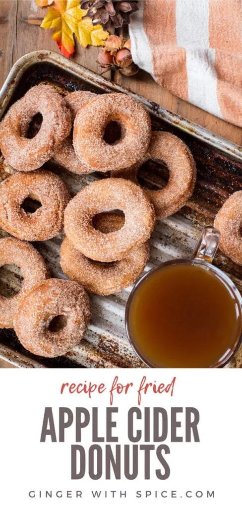 Apple Cider Donuts and a cup of apple cider on a metal pan. Pinterest pin.