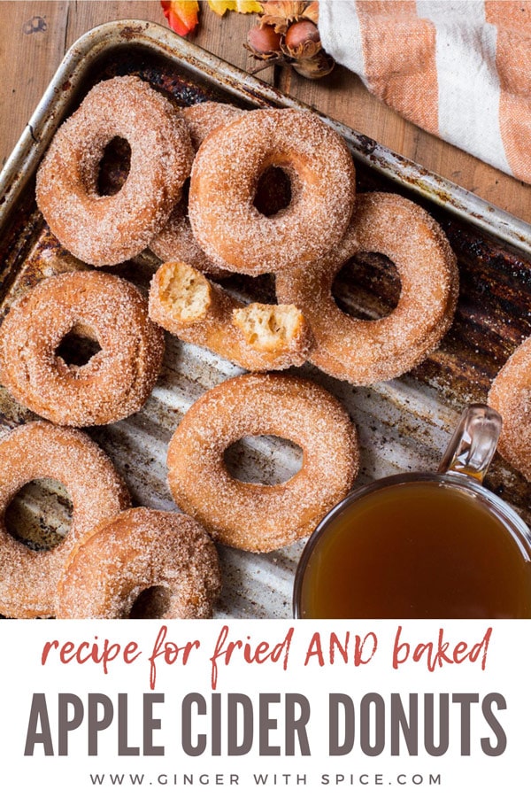 Apple cider donuts coated in sugar, on a metal pan. Pinterest pin.