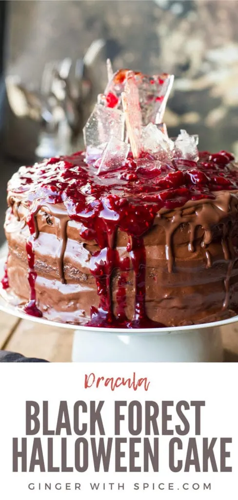 Cherry chocolate cake topped with cherry filling and sugar glass shards, close up. Pinterest pin.