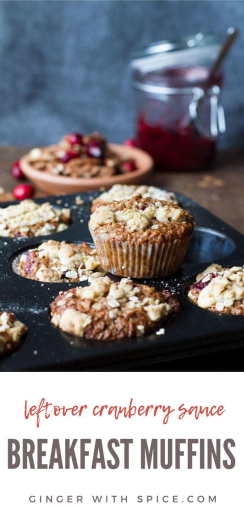 A muffin tin with cranberry sauce breakfast muffins, one standing on top of the tin. Pinterest pin.