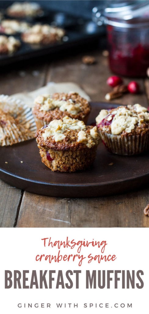 Three cranberry sauce oat breakfast muffins on a wooden plate. Pinterest pin.