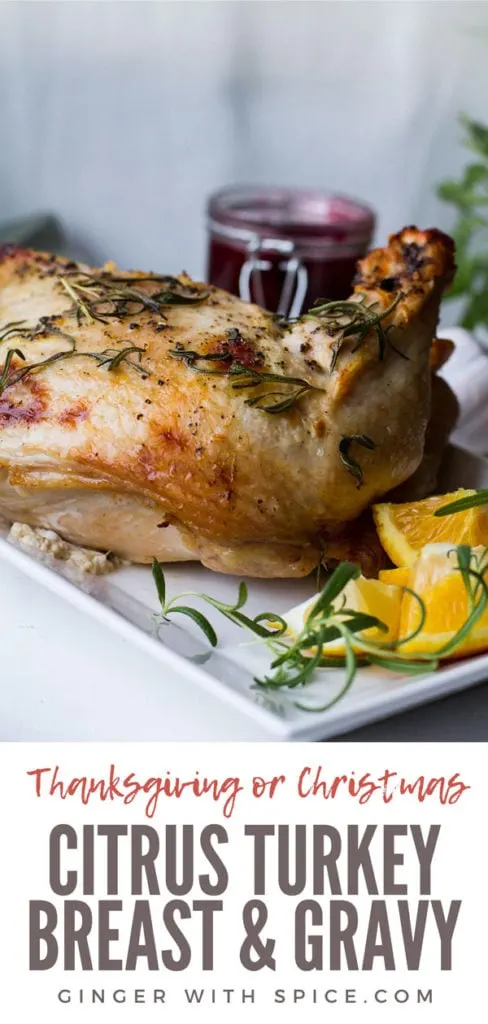 Turkey breast on a white plate, garnished with orange quarters. Pinterest pin.