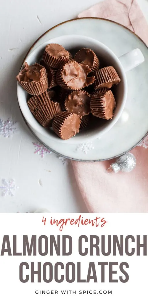 Almond Crunch Milk Chocolates, a few cut open, in a small white cup. Flatlay, pinterest pin.