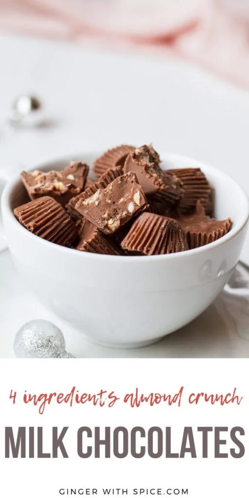 Almond Crunch Milk Chocolates, a few cut open, in a small white cup. Pinterest pin.