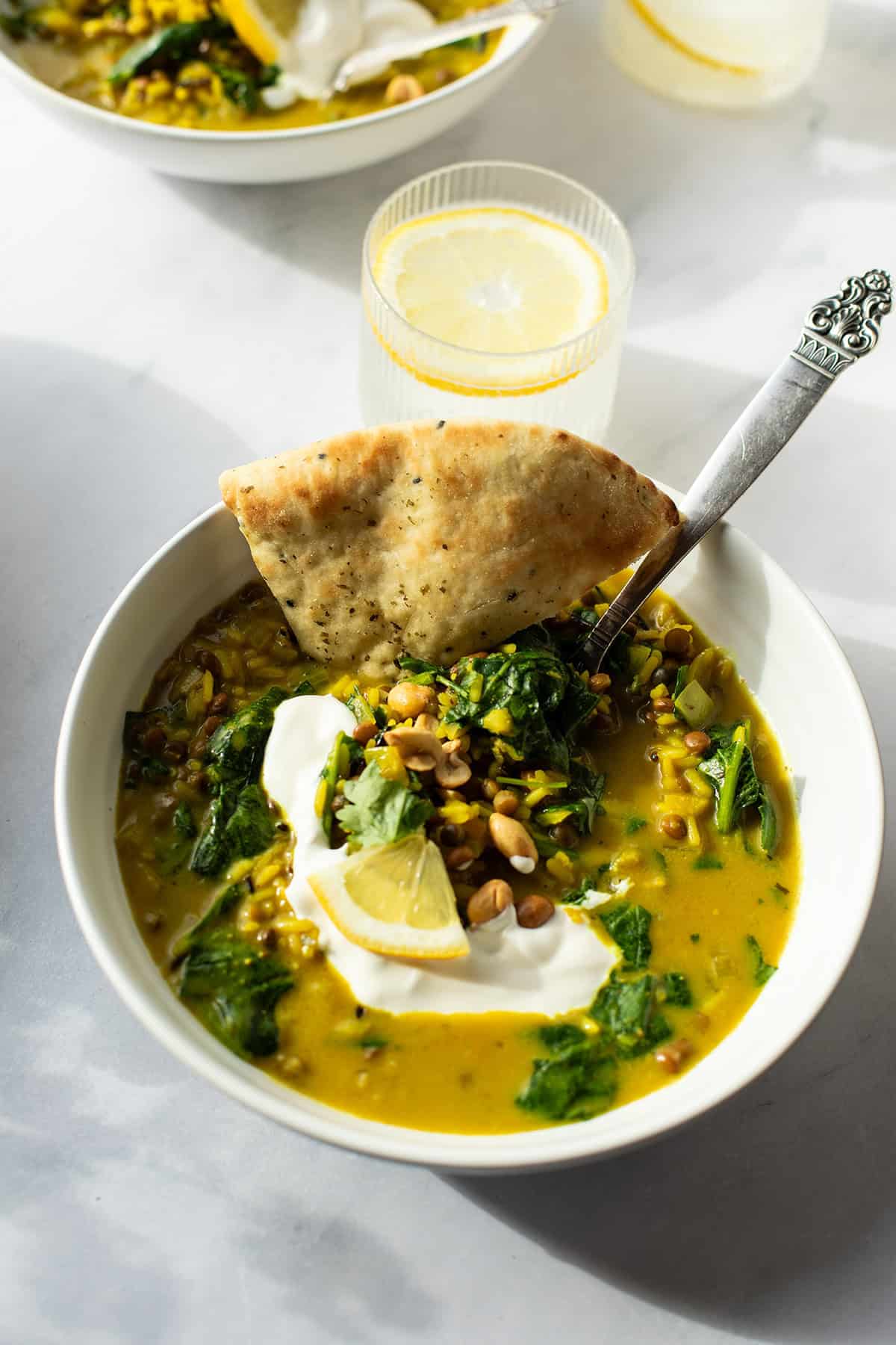 Closeup of a white bowl of lentil coconut curry.