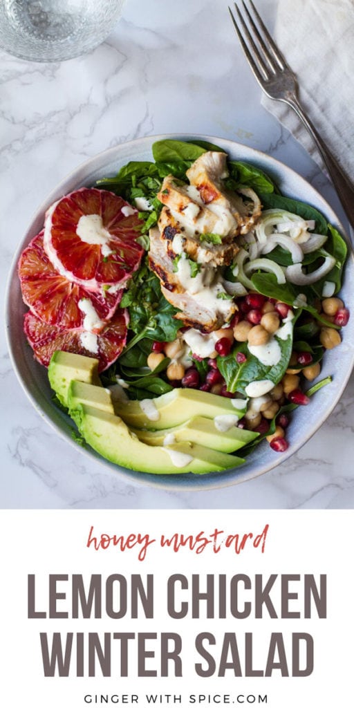 Big bowl with salad topped with chicken, avocado and blood orange slices. White background. Pinterest pin.