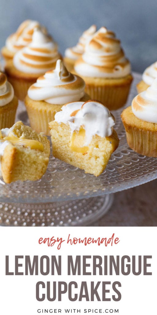 Cupcakes on a glass cake stand, with torched Swiss meringue. One cut open to show lemon curd. Pinterest pin with text at the bottom.