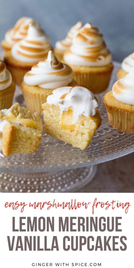 Cupcakes on a glass cake stand, with torched Swiss meringue. One cut open to show lemon curd. Pinterest pin.