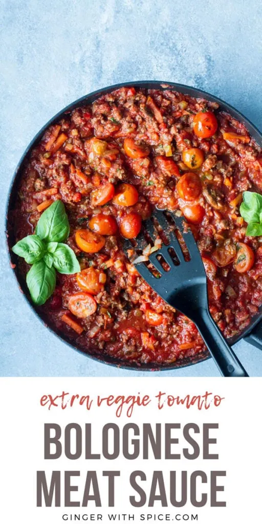 Bolognese sauce in a large skillet, garnished with fresh basil. Blue background. Pinterest pin with text.