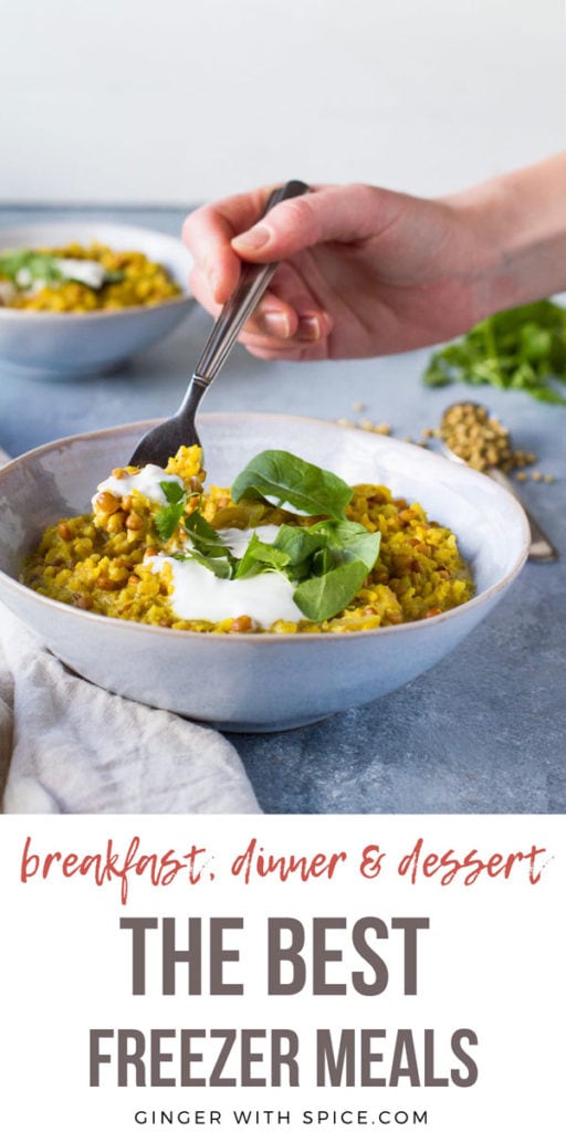 Lentil curry with hand taking a fork with curry. Text overlay: the best freezer meals. Pinterest pin.