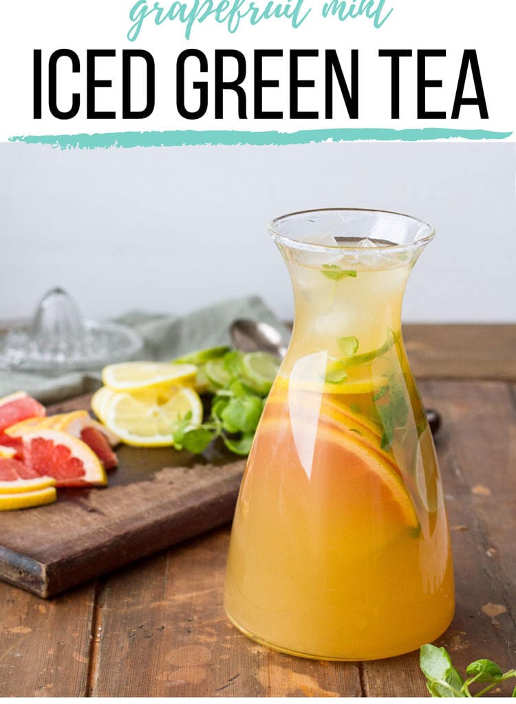 A carafe with iced green tea and sliced citrus fruit. Pinterest pin.