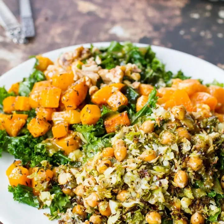 Butternut squash kale salad on a white plate.