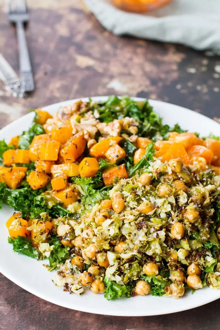 Butternut squash kale salad on a white plate.