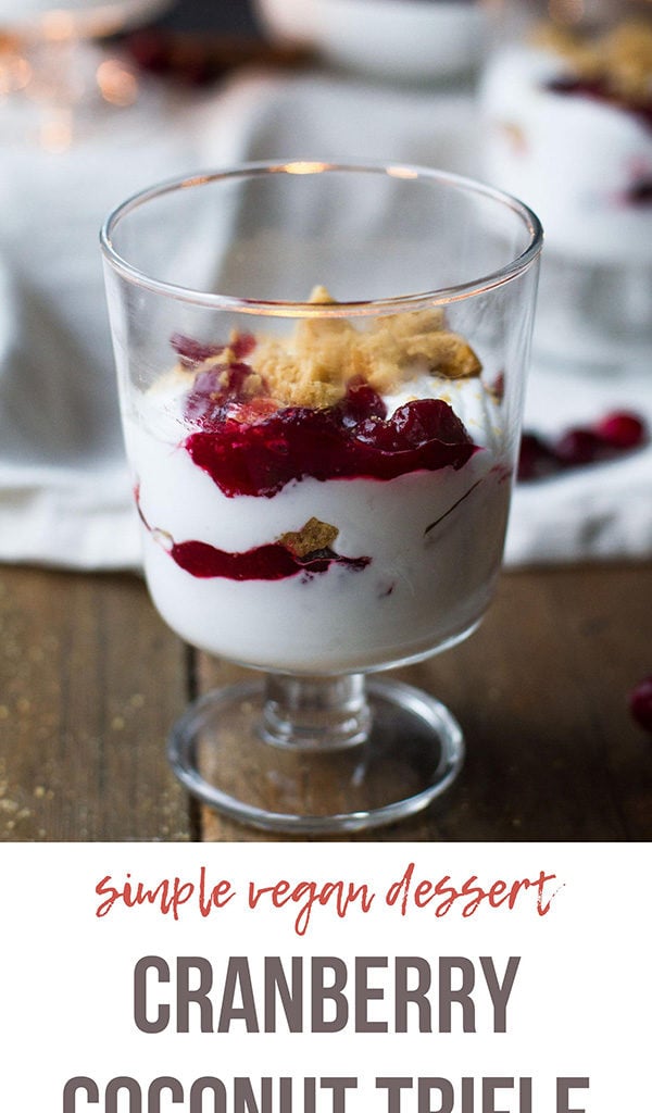 A dessert glass with cranberry coconut trifle. Pinterest pin.