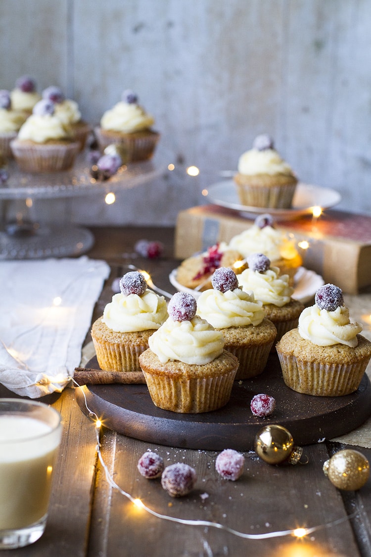 Gingerbread cupcakes with eggnog frosting and one sugared cranberry at the top.