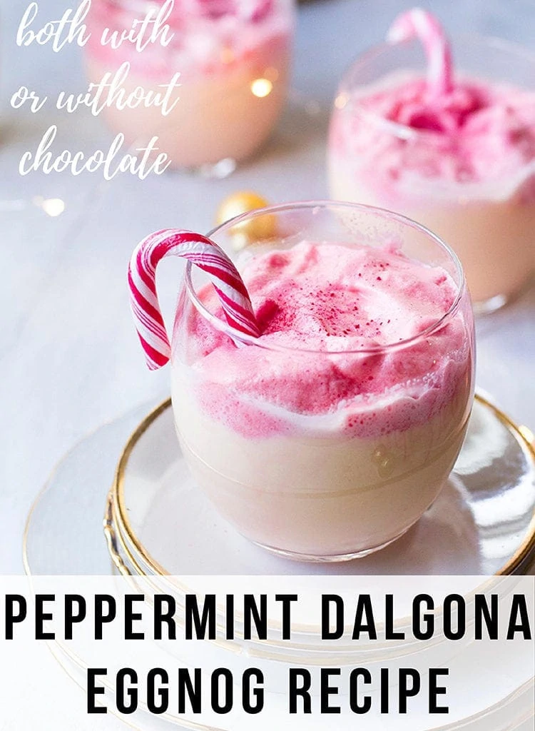 Round glass with eggnog and fluffy pink dalgona, garnished with candy cane. Pinterest pin.