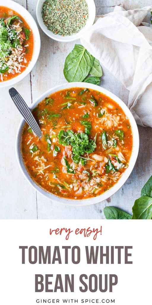 Tomato white bean soup in a large white bowl, garnished with parsley. Seen from above. Long Pinterest pin with text at the bottom.