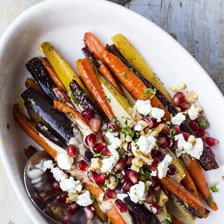 Roasted carrots topped with feta cheese, pomegranate arils and chopped walnuts.