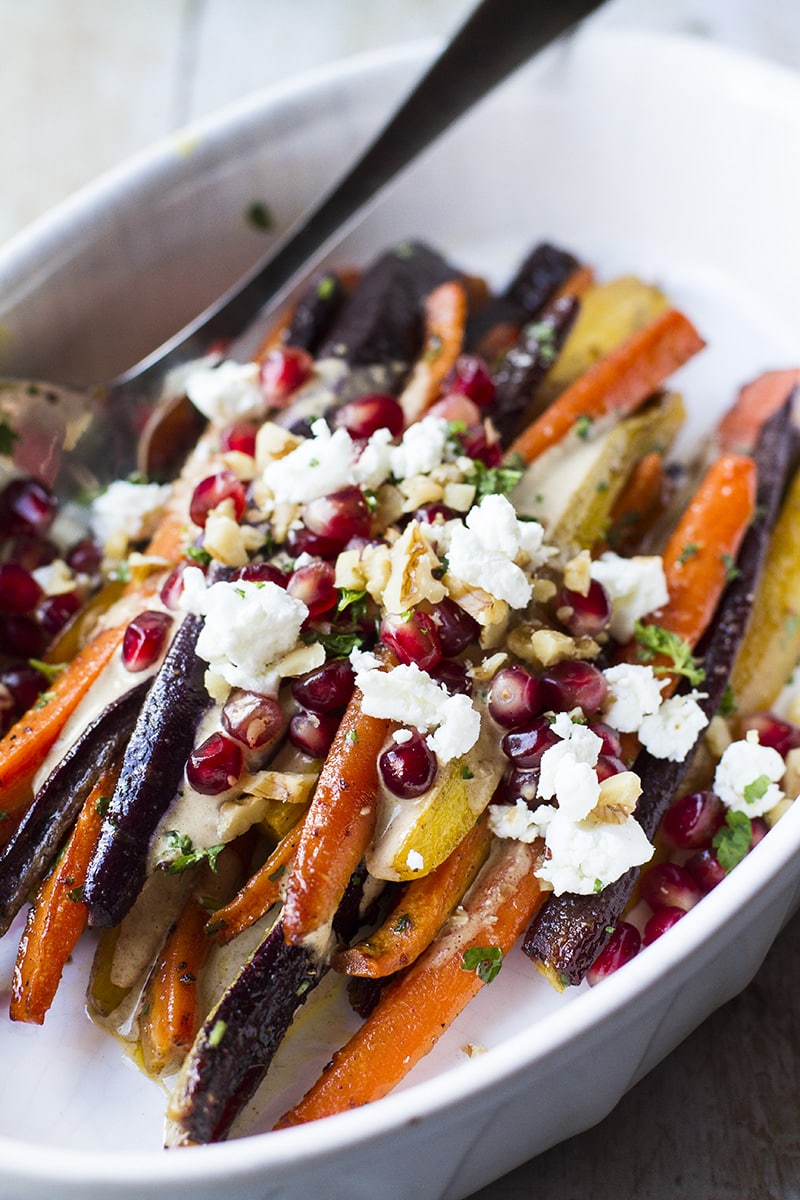 Close-up of the carrots with toppings like feta cheese and pomegranate arils.
