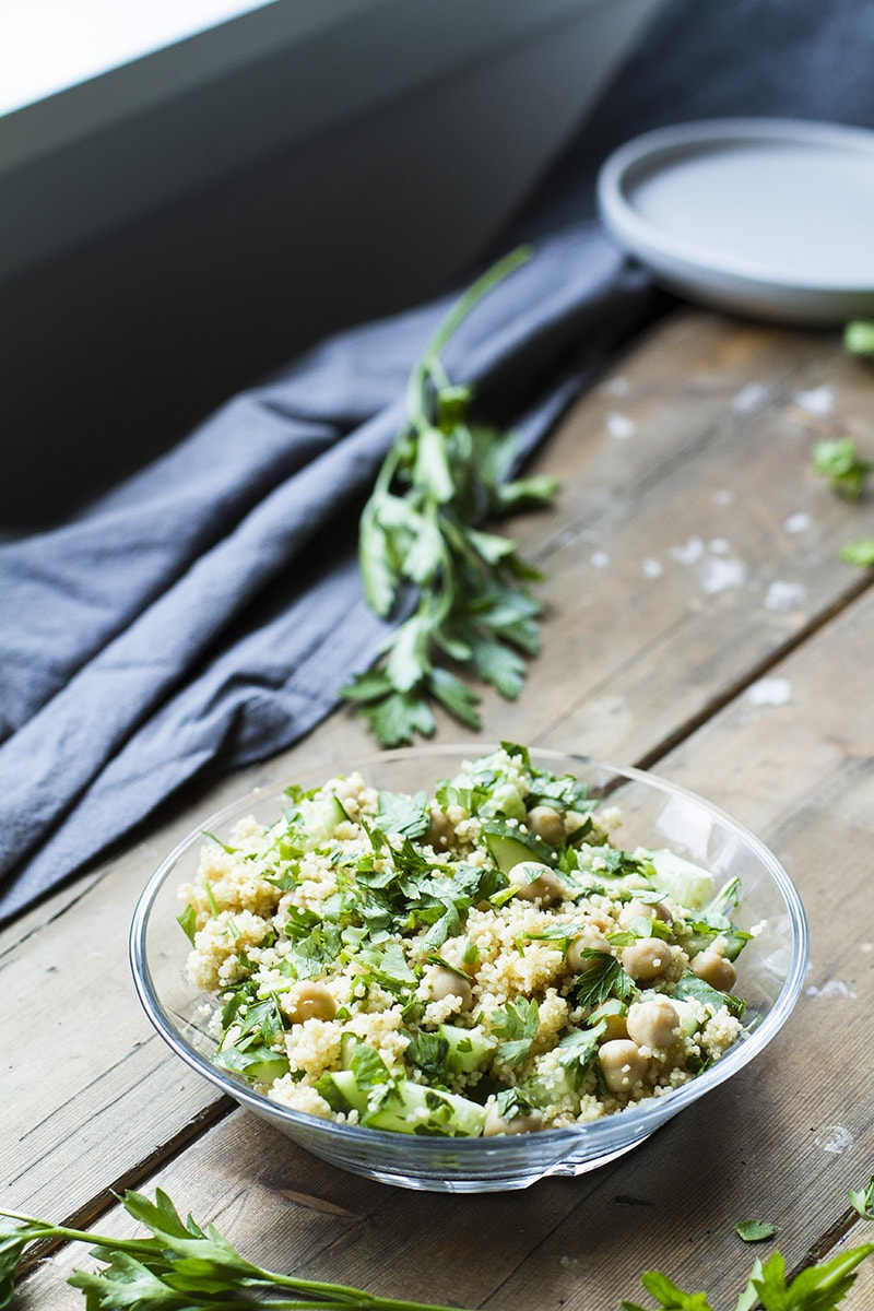 Glass bowl with herb chickpea couscous.