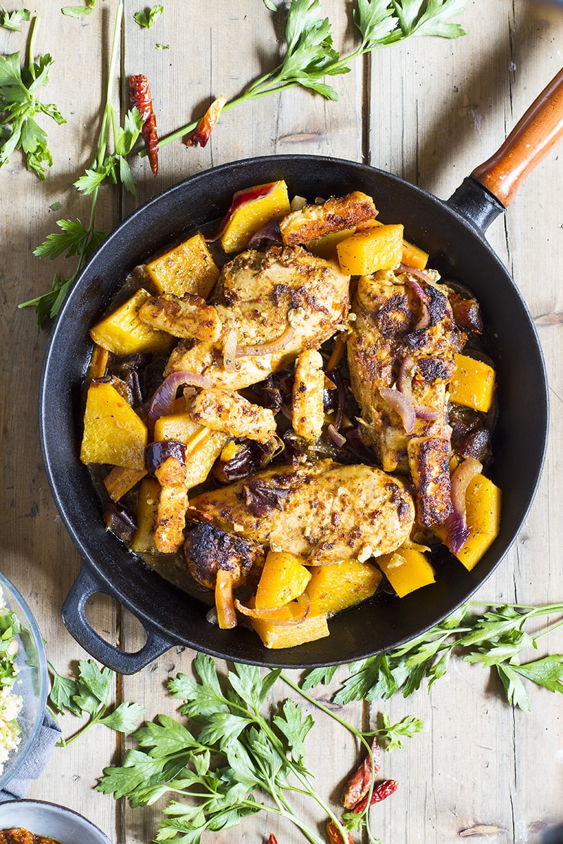 Chicken breast and butternut squash in a skillet.