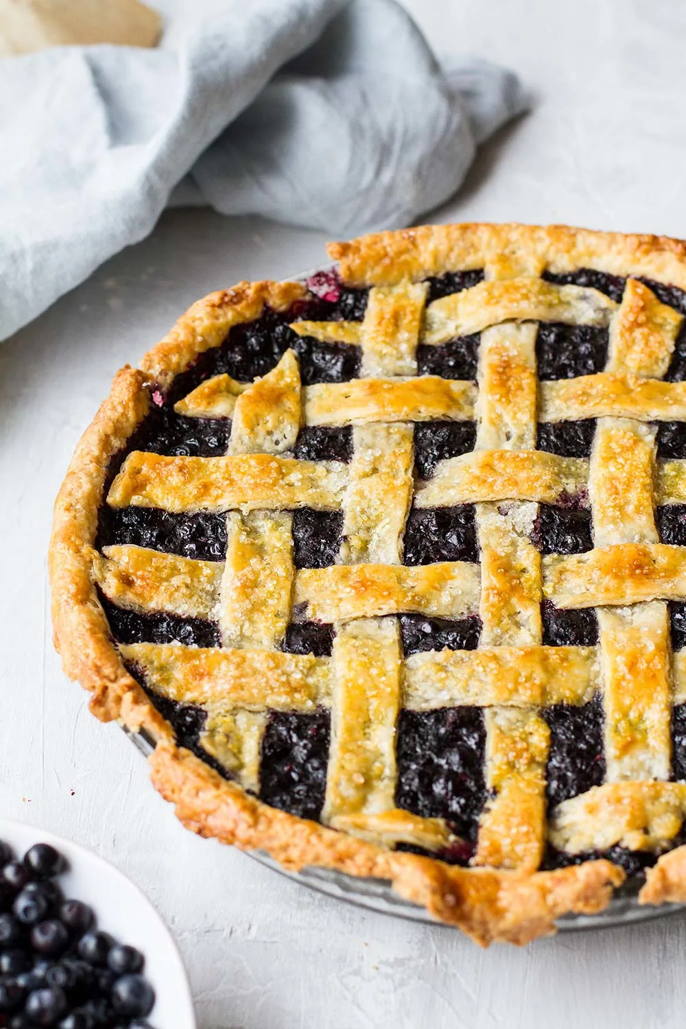 Baked blueberry pie with lattice top, not showing all of it.