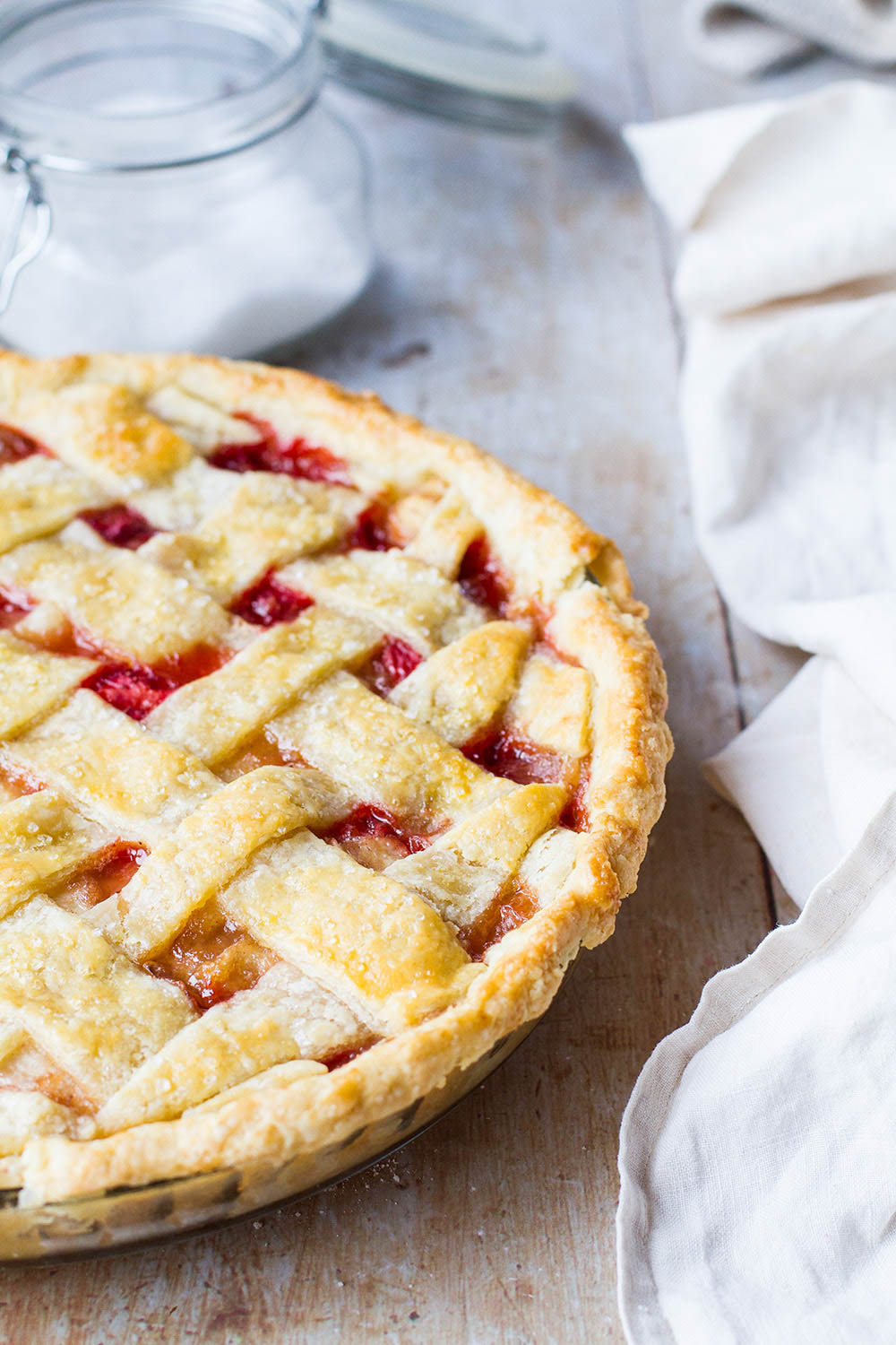 Strawberry peach pie seen from the side.