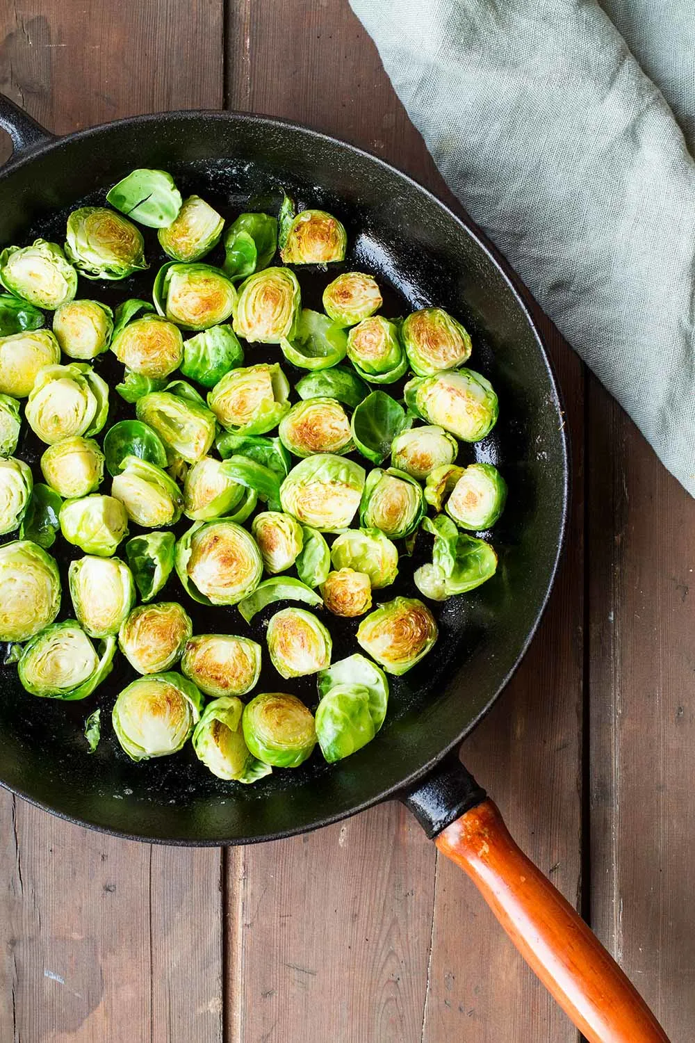 Brussels sprouts with crispy exterior in a cast iron skillet.