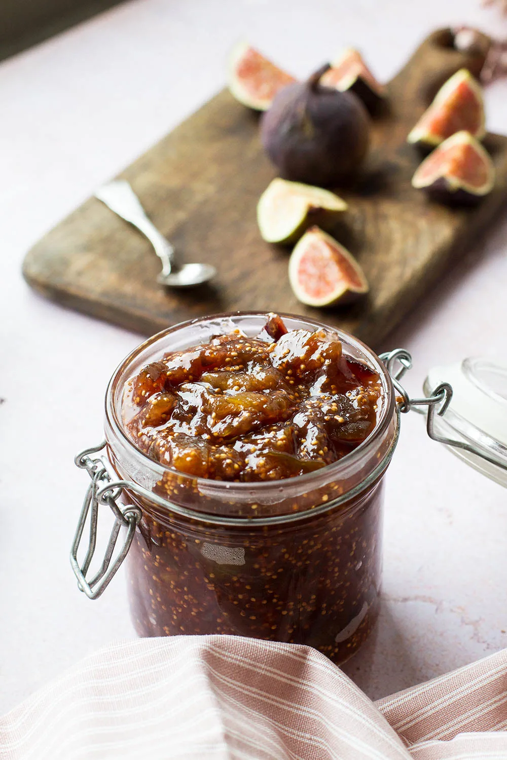 Fig jam in a glass jar.