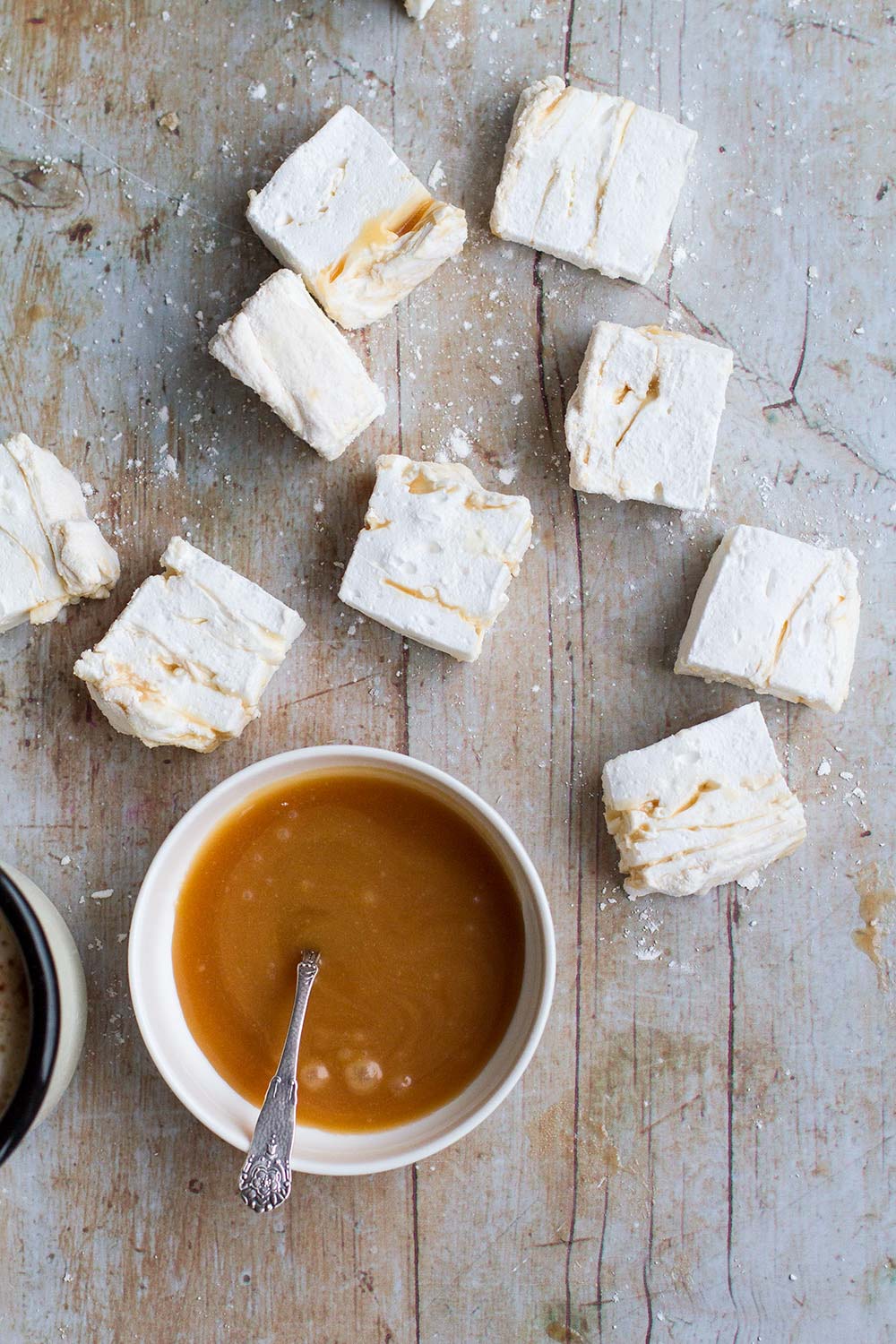 Marshmallows with a small bowl of salted caramel.